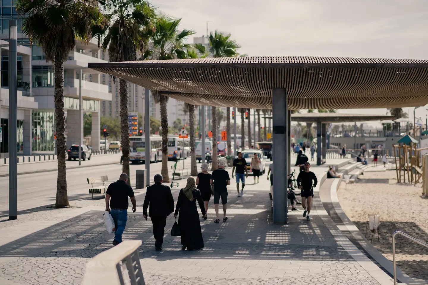 People walking through a vibrant Tel Aviv street